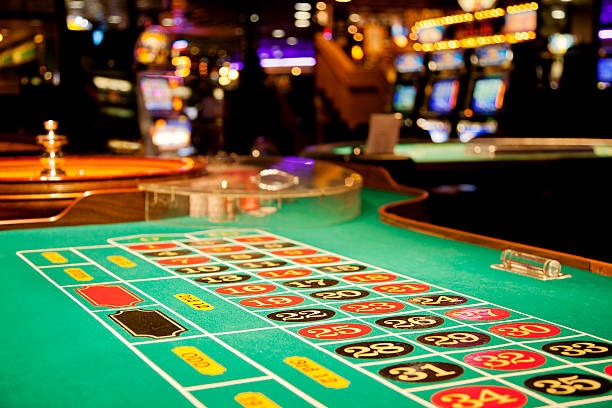 Live dealer studio view with roulette and baccarat tables